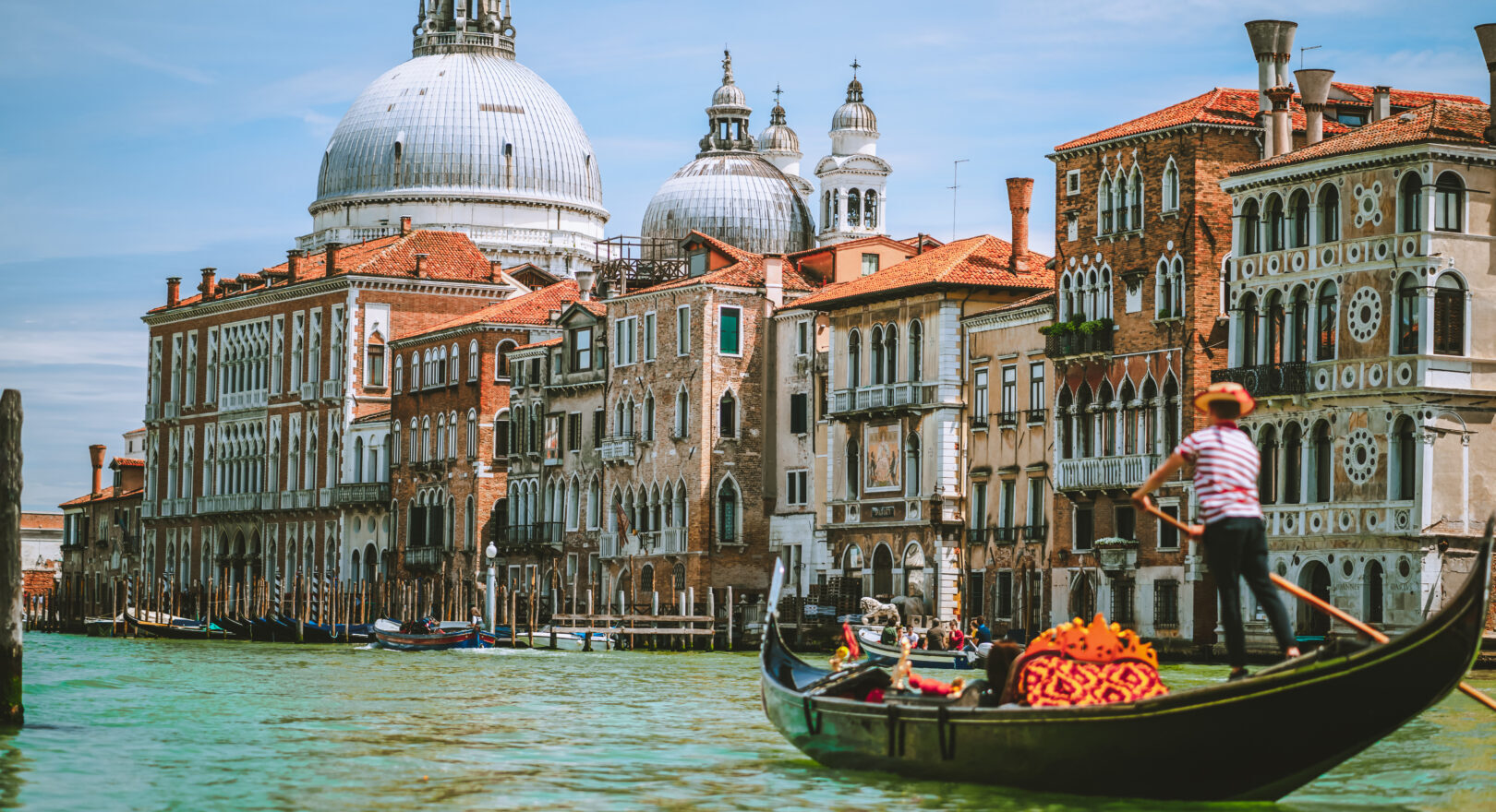 Grand Canal, Traditional Gondola and Basilica Santa Maria della Salute in background, Venice, Italy.